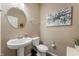 Elegant half bath featuring pedestal sink, circular mirror, and tasteful decor creating a welcoming space at 315 Limerick Ln, Pendleton, IN 46064