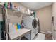 Functional laundry room with modern washer and dryer, ample shelving, and a convenient folding table at 315 Limerick Ln, Pendleton, IN 46064
