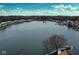 Expansive aerial view of a serene lake surrounded by homes, offering tranquil waterfront living at 3260 Eddy Ct, Indianapolis, IN 46214