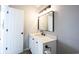 Bathroom with white vanity, black hardware, framed mirror and white door at 3260 Eddy Ct, Indianapolis, IN 46214
