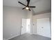 A gray bedroom featuring a ceiling fan, closet, doorway, and gray carpet at 3260 Eddy Ct, Indianapolis, IN 46214