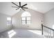 Bedroom featuring vaulted ceilings, carpet floor, and large arched window at 3260 Eddy Ct, Indianapolis, IN 46214