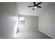 A gray bedroom featuring a ceiling fan, window, and gray carpet at 3260 Eddy Ct, Indianapolis, IN 46214
