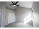 A gray bedroom featuring a ceiling fan, closet, window, and gray carpet at 3260 Eddy Ct, Indianapolis, IN 46214