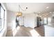 Bright dining area shows wood floors, a hanging pendant light fixture, and an open view of kitchen and entryway at 3260 Eddy Ct, Indianapolis, IN 46214