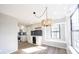 Open dining area features a built-in beverage bar, a large window, and a unique, decorative hanging light fixture at 3260 Eddy Ct, Indianapolis, IN 46214