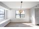 Bright dining room boasts wood floors, natural light from a large window, and a stylish pendant light fixture at 3260 Eddy Ct, Indianapolis, IN 46214