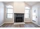 Living room fireplace with shiplap accent wall and a set of windows; a modern door leads to the backyard at 3260 Eddy Ct, Indianapolis, IN 46214