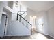 Bright foyer with staircase leading to the upper level, showcasing modern design and a welcoming entrance for guests at 3260 Eddy Ct, Indianapolis, IN 46214