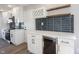 Modern kitchen displays white cabinets, a built-in wine rack, floating shelves, and stainless steel appliances at 3260 Eddy Ct, Indianapolis, IN 46214