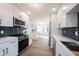 This kitchen has a large island, white cabinets, stainless steel appliances and is well lit at 3260 Eddy Ct, Indianapolis, IN 46214
