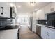 Bright kitchen with stainless steel appliances, white cabinets, and a seamless flow into the dining area at 3260 Eddy Ct, Indianapolis, IN 46214