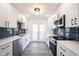 Updated kitchen with stainless steel appliances, white cabinets, dark backsplash, and plenty of countertop space at 3260 Eddy Ct, Indianapolis, IN 46214