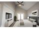 A bedroom with a vaulted ceiling, white shiplap accent wall, and double doors to the yard at 3260 Eddy Ct, Indianapolis, IN 46214