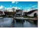 Charming home's rear exterior showing a deck overlooking the serene water, perfect for relaxing lakeside living at 3260 Eddy Ct, Indianapolis, IN 46214