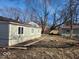 A spacious backyard featuring a detached garage, mature trees, and a cozy, private feel at 3844 Esquire Ct, Indianapolis, IN 46226