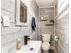 Charming half bathroom with modern sink, light gray wood paneling, floating shelves, and stylish decor at 421 S East St, Plainfield, IN 46168