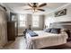 Cozy bedroom with a ceiling fan, a barn door, and lots of natural light from two bright double windows at 421 S East St, Plainfield, IN 46168