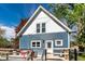 Charming home exterior featuring a blue facade, gabled roof, and a spacious deck with outdoor seating at 421 S East St, Plainfield, IN 46168