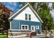 Charming home exterior featuring a blue facade, gabled roof, and a spacious deck with outdoor seating at 421 S East St, Plainfield, IN 46168