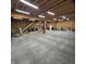 Vast garage interior with unfinished walls, concrete flooring, and wood beam ceiling, offering ample storage space at 421 S East St, Plainfield, IN 46168