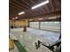 Spacious garage featuring two overhead doors, concrete floors, and wood beam ceiling with ample lighting at 421 S East St, Plainfield, IN 46168
