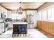 Modern kitchen with white cabinets, stainless steel appliances, an island with seating, and stylish backsplash at 421 S East St, Plainfield, IN 46168