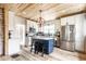 Updated kitchen with white cabinetry, stainless steel appliances, and a contrasting blue kitchen island with seating at 421 S East St, Plainfield, IN 46168
