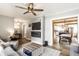 Open-concept living room flowing into a kitchen, featuring hardwood floors and a modern fireplace at 421 S East St, Plainfield, IN 46168