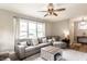 Bright living room with modern furniture, large windows, and stylish ceiling fan at 421 S East St, Plainfield, IN 46168