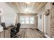 Cozy home office with wood ceiling, exposed brick wall, and ample natural light at 421 S East St, Plainfield, IN 46168