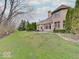 Sprawling backyard with lush green grass, mature trees, and a charming patio area for outdoor relaxation at 443 Mclaren Ln, Carmel, IN 46032