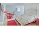 Charming bedroom featuring red and white decor, including a four-poster bed and plush armchair at 443 Mclaren Ln, Carmel, IN 46032