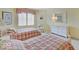 Comfortable bedroom featuring two twin beds, complemented by natural light and a cozy reading nook at 443 Mclaren Ln, Carmel, IN 46032