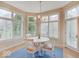 Inviting breakfast nook with a white table set, chandelier, and bright natural lighting at 443 Mclaren Ln, Carmel, IN 46032