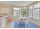 Charming breakfast nook with ample windows, a chandelier, and a cozy table setup at 443 Mclaren Ln, Carmel, IN 46032