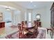 Elegant dining area featuring hardwood floors, white walls, and seamless transition to the entryway at 443 Mclaren Ln, Carmel, IN 46032