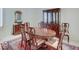 Formal dining room featuring a wood table with seating for six, a china cabinet, and patterned rug at 443 Mclaren Ln, Carmel, IN 46032