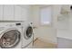 Well-lit laundry room with modern washer and dryer units and ample storage space at 443 Mclaren Ln, Carmel, IN 46032