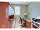 Home office with built-in shelves, a wooden desk, and a comfortable office chair at 443 Mclaren Ln, Carmel, IN 46032