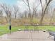 Patio with metal outdoor furniture and decor with green space and woods in the background at 443 Mclaren Ln, Carmel, IN 46032