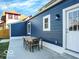 Backyard concrete patio of the home with table, chairs and a white door at 46 N Denny St, Indianapolis, IN 46201