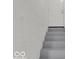 Basement stairs leading to an exterior door with painted brick at 46 N Denny St, Indianapolis, IN 46201