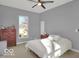 Bedroom with wood floors, ceiling fan, and a dresser at 46 N Denny St, Indianapolis, IN 46201
