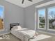 Bright bedroom with carpet and multiple windows bringing in natural light at 46 N Denny St, Indianapolis, IN 46201