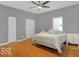 Bright bedroom with wood floors, ceiling fan, and ample closet space at 46 N Denny St, Indianapolis, IN 46201