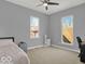 Spacious bedroom with two windows allowing natural light and ceiling fan for comfort at 46 N Denny St, Indianapolis, IN 46201