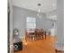 Bright dining area with hardwood floors, table with seating for eight, and modern light fixture at 46 N Denny St, Indianapolis, IN 46201