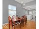 Open concept dining area with hardwood floors, modern lighting, and views into the kitchen at 46 N Denny St, Indianapolis, IN 46201