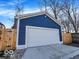 View of the home's detached, one-car garage featuring a fresh coat of blue paint and a white door at 46 N Denny St, Indianapolis, IN 46201